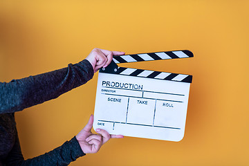 Image showing movie clapper isolated on yellow background