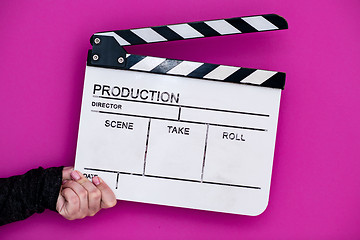 Image showing movie clapper on pink purple violet background