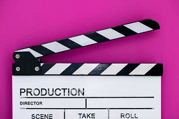 Image showing movie clapper on pink purple violet background