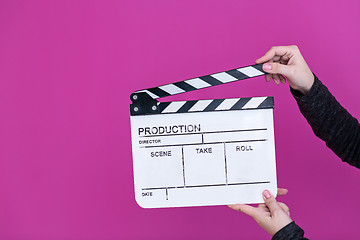 Image showing movie clapper on pink purple violet background