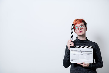 Image showing woman on white background holding movie clapper