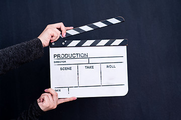 Image showing movie clapper on black chalkboard background