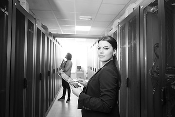 Image showing Female engineer working on a tablet computer in server room