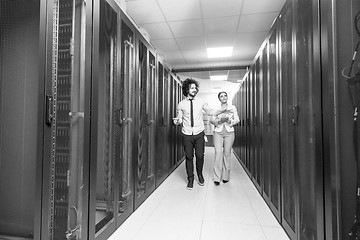 Image showing engineer showing working data center server room to female chief