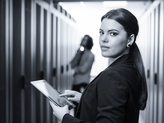 Image showing Female engineer working on a tablet computer in server room