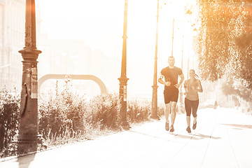 Image showing young couple jogging  in the city