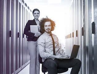 Image showing Team of young technicians working together on servers