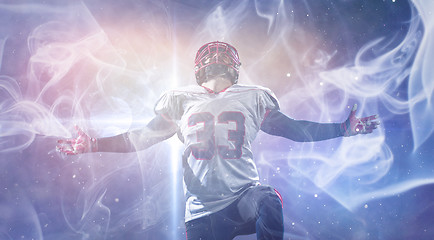 Image showing american football player celebrating after scoring a touchdown