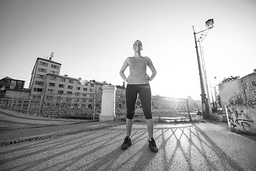 Image showing portrait of a jogging woman at sunny morning