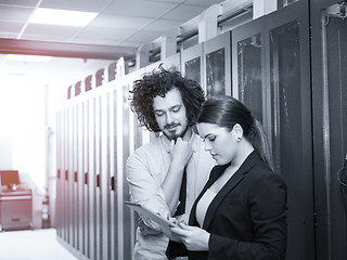 Image showing engineer showing working data center server room to female chief