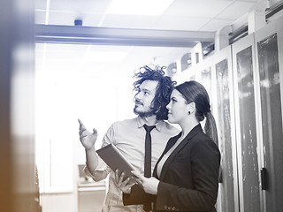 Image showing engineer showing working data center server room to female chief