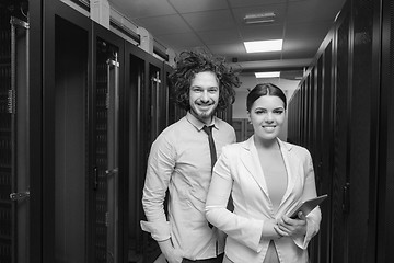 Image showing engineer showing working data center server room to female chief