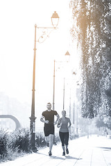 Image showing young couple jogging  in the city