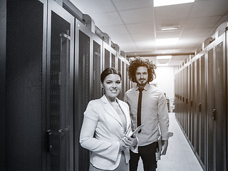 Image showing engineer showing working data center server room to female chief