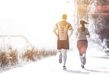 Image showing young couple jogging  in the city