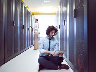 Image showing young technicians working together on servers