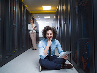 Image showing young technicians working together on servers