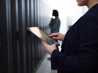 Image showing Female engineer working on a tablet computer in server room