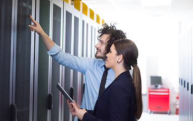 Image showing engineer showing working data center server room to female chief