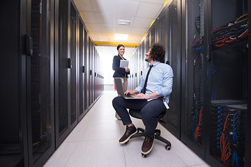 Image showing Team of young technicians working together on servers