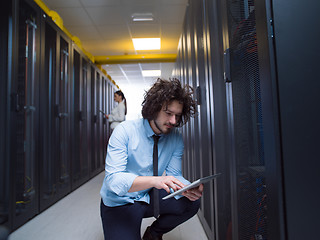 Image showing young technicians working together on servers