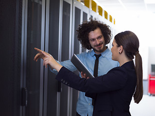 Image showing engineer showing working data center server room to female chief