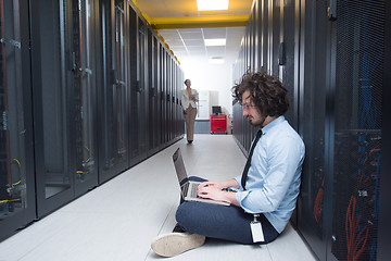 Image showing Team of young technicians working together on servers