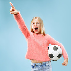 Image showing Fan sport teen player holding soccer ball isolated on blue background