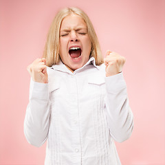 Image showing Isolated on pink young casual teen girl shouting at studio