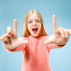 Image showing Beautiful teen girl looking suprised isolated on blue