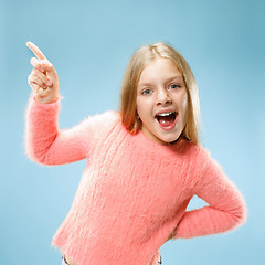 Image showing Beautiful teen girl looking suprised isolated on blue