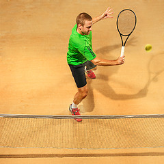 Image showing The one jumping player, caucasian fit man, playing tennis on the earthen court