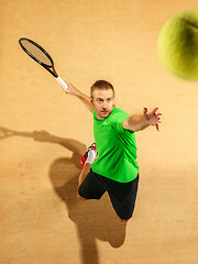 Image showing The one jumping player, caucasian fit man, playing tennis on the earthen court