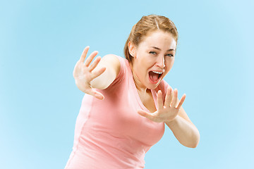 Image showing Portrait of the scared woman on blue