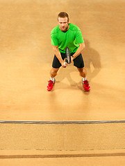 Image showing The one jumping player, caucasian fit man, playing tennis on the earthen court