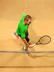 Image showing The one jumping player, caucasian fit man, playing tennis on the