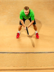 Image showing The one jumping player, caucasian fit man, playing tennis on the earthen court