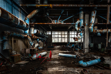 Image showing Dark industrial interior with pipes