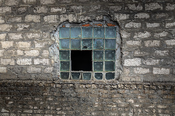 Image showing Broken window on abandoned factory wall