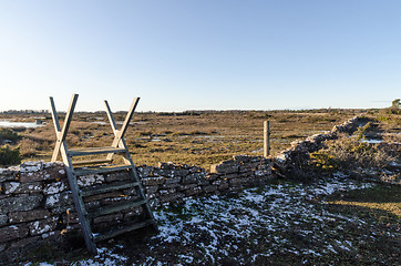 Image showing Wooden stile across an old dry stone wall