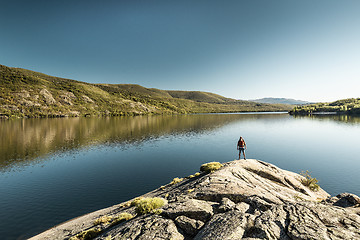 Image showing Man hiking near a beautiful lake