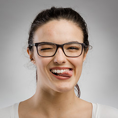 Image showing Woman biting her tongue