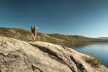 Image showing Man hiking near a beautiful lake
