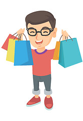 Image showing Happy caucasian boy holding shopping bags.