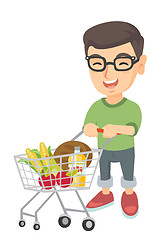 Image showing Little caucasian boy with his shopping trolley.