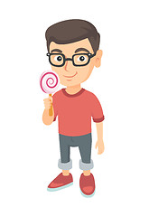 Image showing Little caucasian boy holding a lollipop candy.