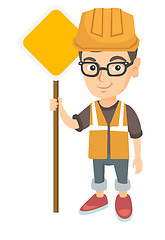 Image showing Little caucasian builder boy holding road sign.