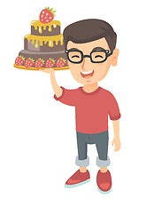 Image showing Little caucasian boy holding a chocolate cake.