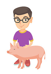 Image showing Caucasian farmer boy in glasses stroking a pig.