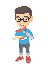 Image showing Boy eating sausage and fried egg for breakfast.